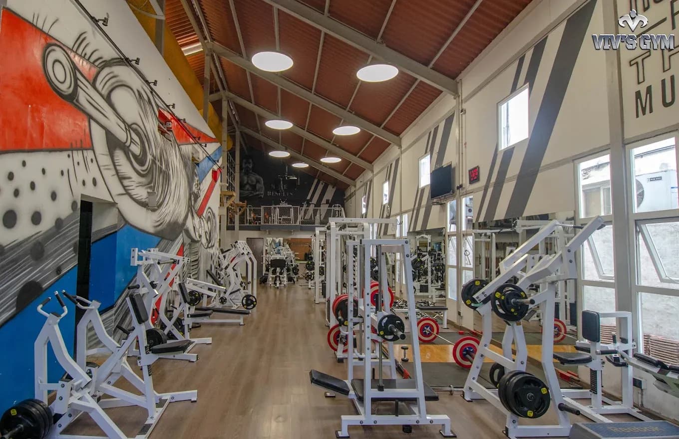 The floor of a gym, racks and machines
